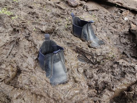 kids boots stuck in mud.